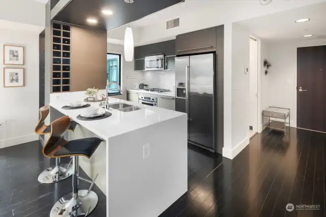 The chef's kitchen has been upgraded with sleek and stylish quartz countertops.