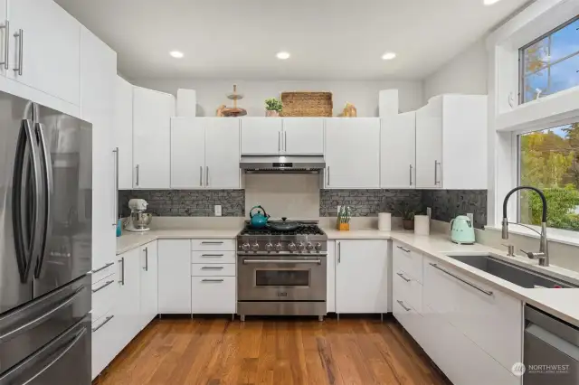 Sleek kitchen with high end appliances that all convey.