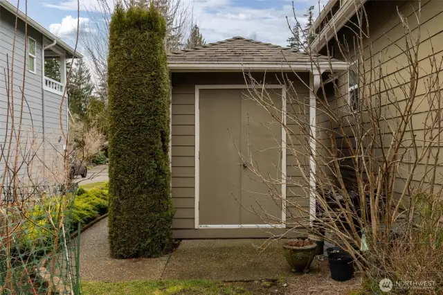 The backyard shed offers extra storage space, perfect for tools, gardening supplies, or seasonal items.