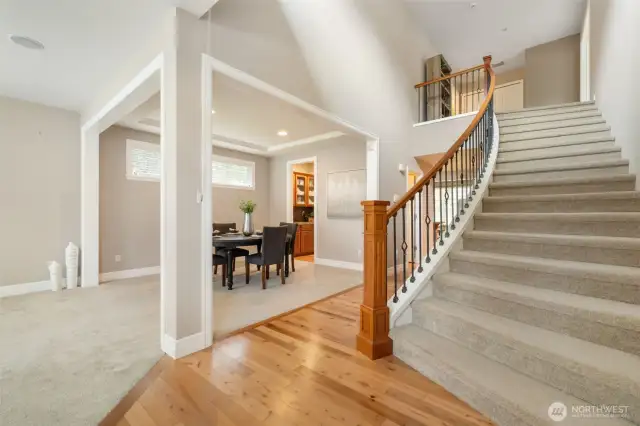 The entryway opens to a spacious layout with an inviting staircase leading to the upper level.