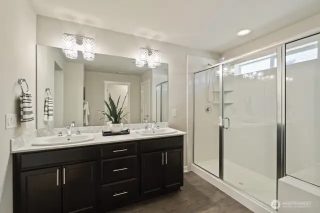 Luxurious primary suite with a spacious shower and bench — spa vibes