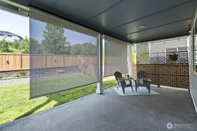 Relax year-round under a covered patio with privacy and heat shades