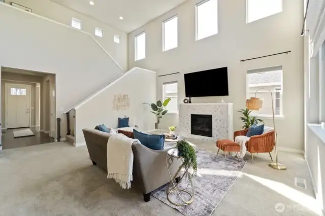 Two-story living room windows with remote-controlled electric shades.