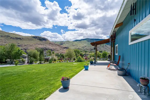 Manicured lawn and spacious patio overlooking the river