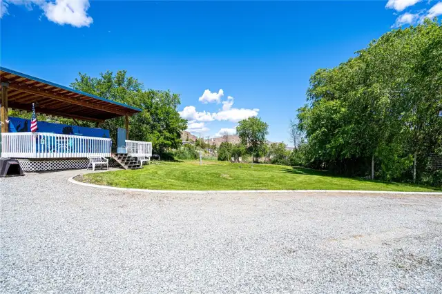 Level property with covered RV pad with a deck and River Views