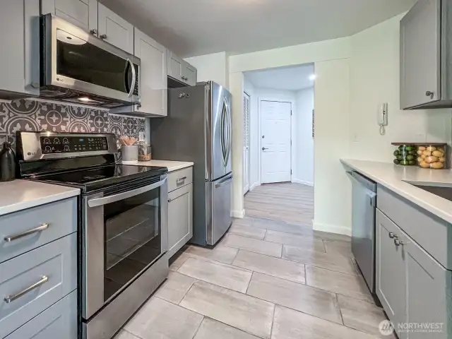 Kitchen with Ceramic tile Flooring and Quartz Counters