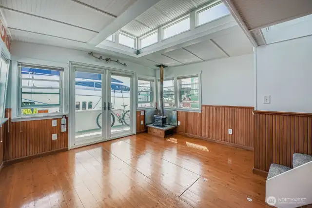 Beautiful hardwood floors and a raised ceiling wrapped in transom windows for an amazing sky view and light.