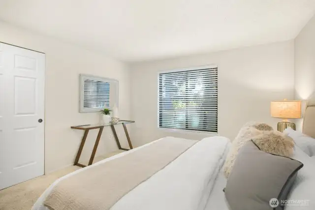 Another view of the primary bedroom highlights the large closet, complete with a built-in organizer for easy storage.