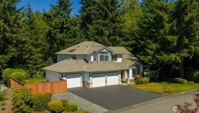 Welcome home to 14543 Kingscross: tucked among soaring evergreens, this striking home offers unmatched seclusion and a serene natural backdrop.