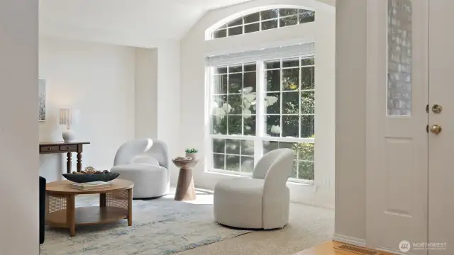 Natural light pours through the grand front window, filling the home with a bright, open, and airy ambiance.