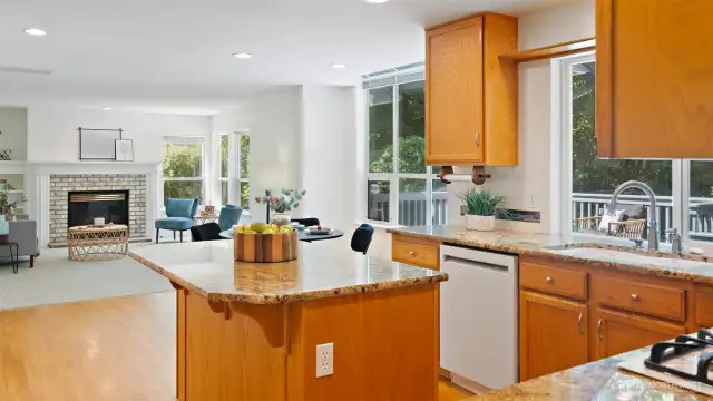 Gorgeous slab granite counters set the stage in a kitchen designed for connection, keeping you part of the conversation while you cook, entertain, or unwind.