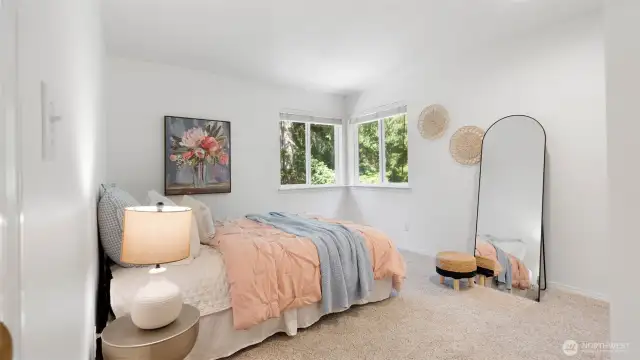 Corner windows in the second bedroom invite in abundant natural light and offer forested views in two directions.
