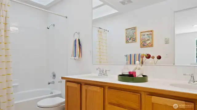 The upper hall bath is bright and inviting, thanks to a skylight that fills the space with natural light and a fresh coat of paint, "Snowbound."