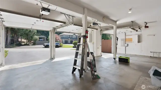 This expansive three-car garage offers plenty of room for vehicles plus a dedicated workshop space for projects and hobbies.