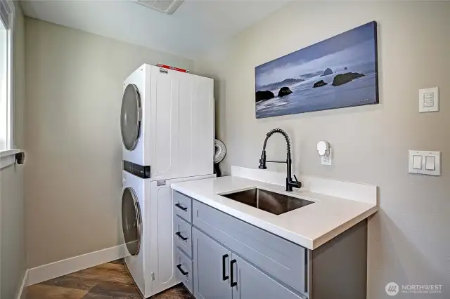 Functional utility room and stackable Washer & Dryer (that do stay), laundry sink and storage.