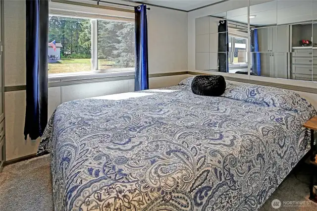 Sunken bedroom has amazing built in wall of cabinets.