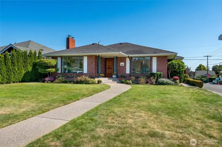 This remarkable mid-century gem sits proudly on a sunny corner lot and radiates charm, history, and thoughtful care at every turn.
