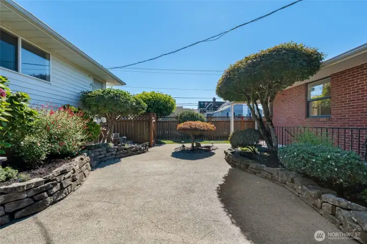 The back patio features low-maintenance turf, perfect for entertaining, barbecuing, or simply enjoying a quiet morning coffee in peace.