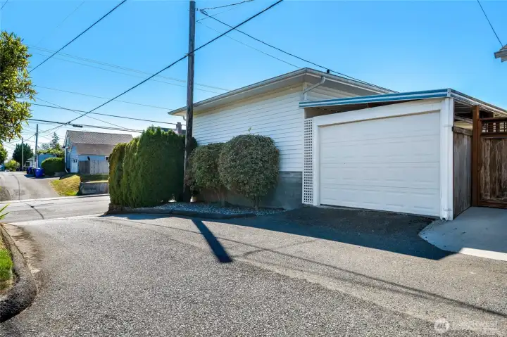 A carport with a secure garage door accessed from the alley.