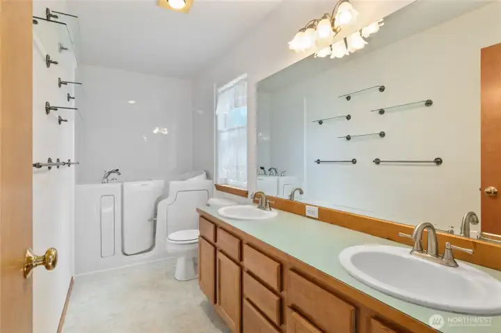 Primary bathroom with handicap accessible bath.