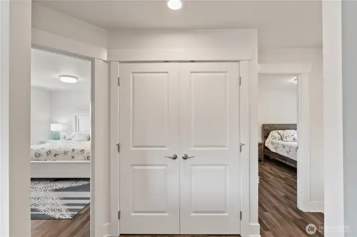 Laundry closet in  hallway between bedrooms