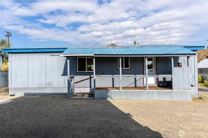 Back of house with extra parking space.