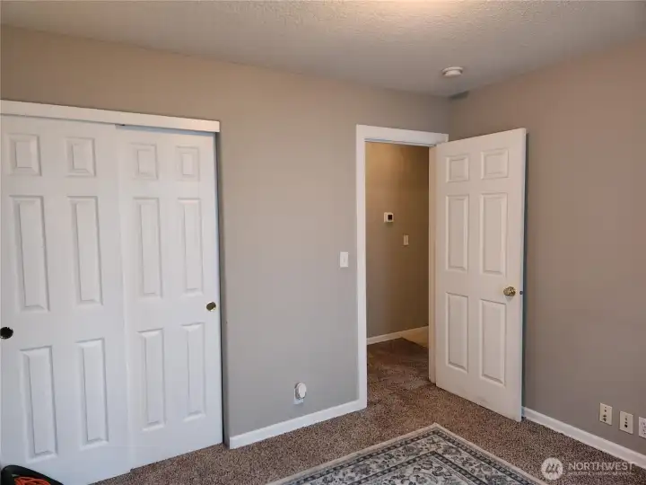 Closet & view of hallway to guest room 1