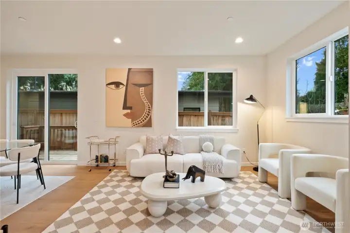 Enter into the airy living room featuring lots of windows and 10' high ceilings.