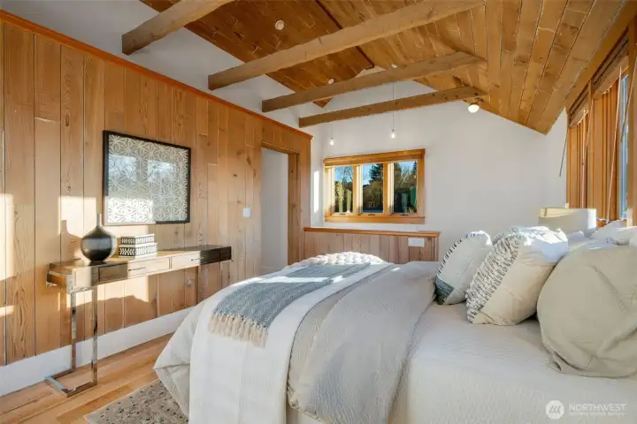 Vaulted ceilings and windows everywhere, the maple floors also continue upstairs.