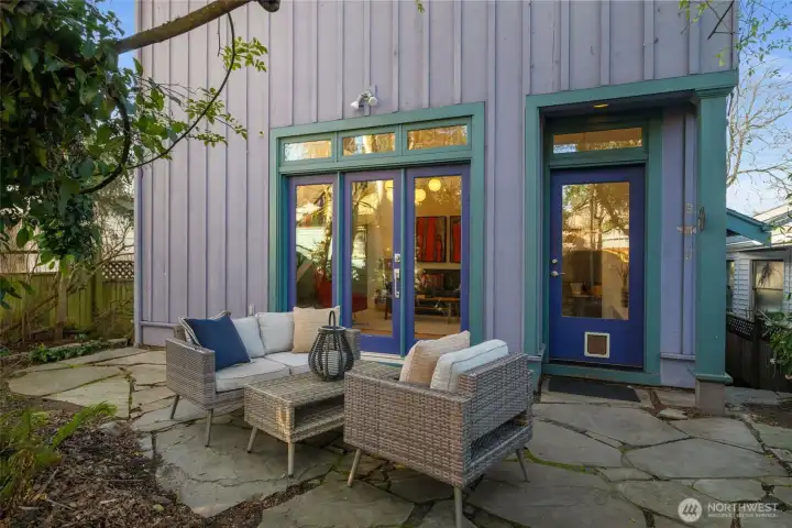 Back of the property with the addition. A good sized patio and fenced on both sides.