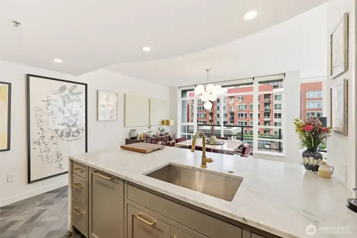 Carrera marble countertops with waterfall edge pennisula with extra deep sunken sink.