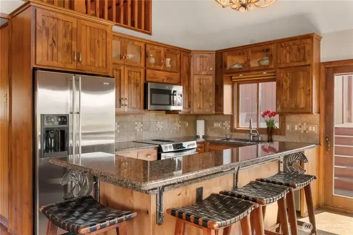 7 foot granite one-piece floating bar with custom fish motif metalwork and supports by local artist Barry Stromberg.