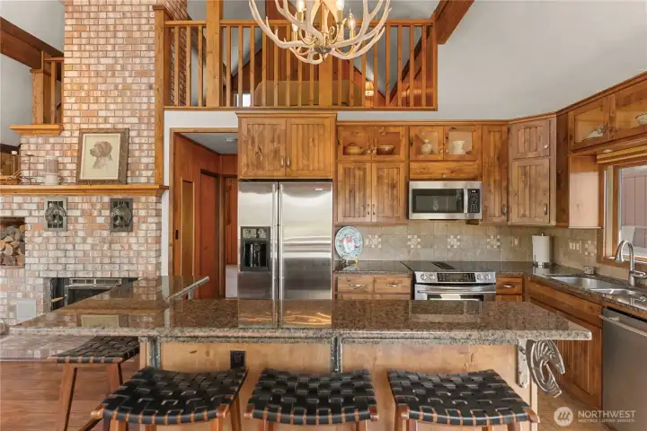 Huntwood natural Alder cabinets with soft close drawers and lighted upper cabinets and under cabinet lighting.