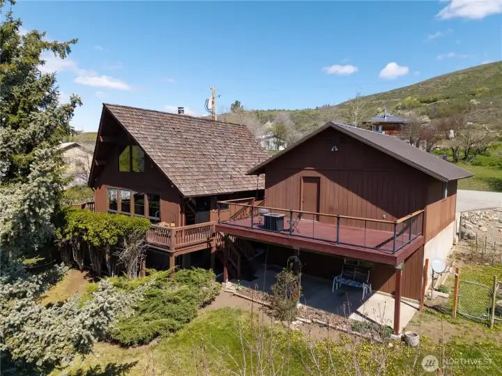 Lower level cement patio leads to the pool room.