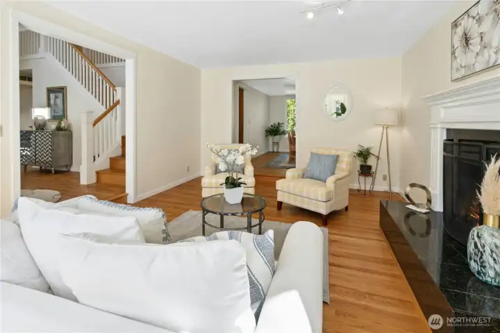 The natural light in this room does the heavy lifting — notice how it bounces off the hardwood floors all the way to the back of the house