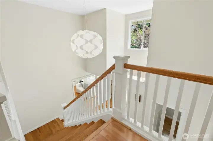 Upper hallway and staircase detail that opens the space and lets the natural light in