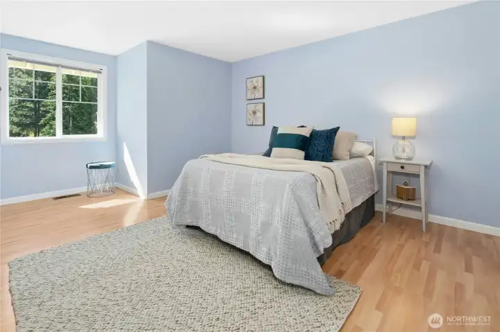 Clean, bright, and bigger than the photo lets on — this bedroom has real floor space and the light to prove it