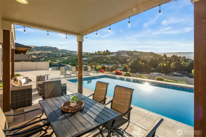 Covered lower patio area and stamped concrete pool deck