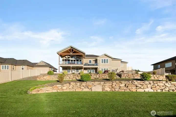 Impeccable landscaping and large flat grass areas