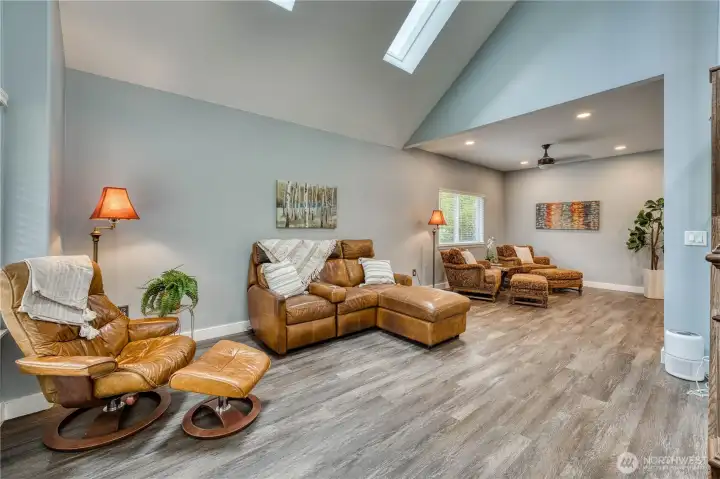 Family room with vaulted ceilings and skylights makes this space light and bright.