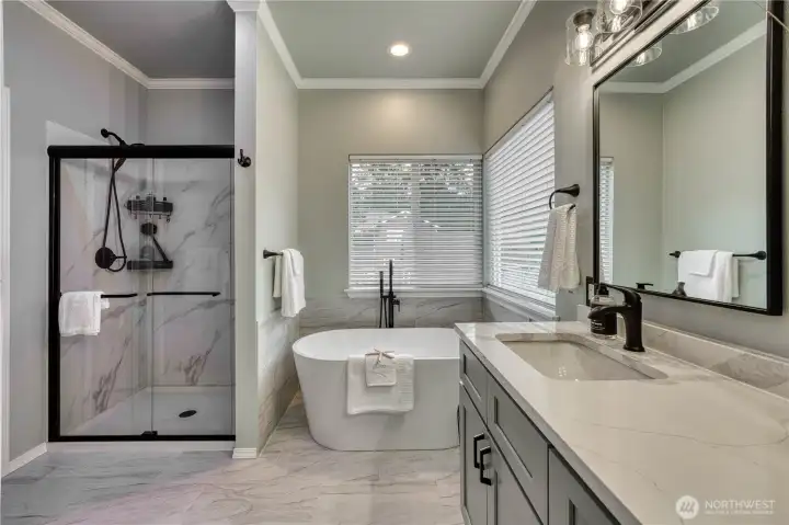 Newly updated Primary bath with freestanding tub, quartz counters and tile shower and floors add today's modern touches.