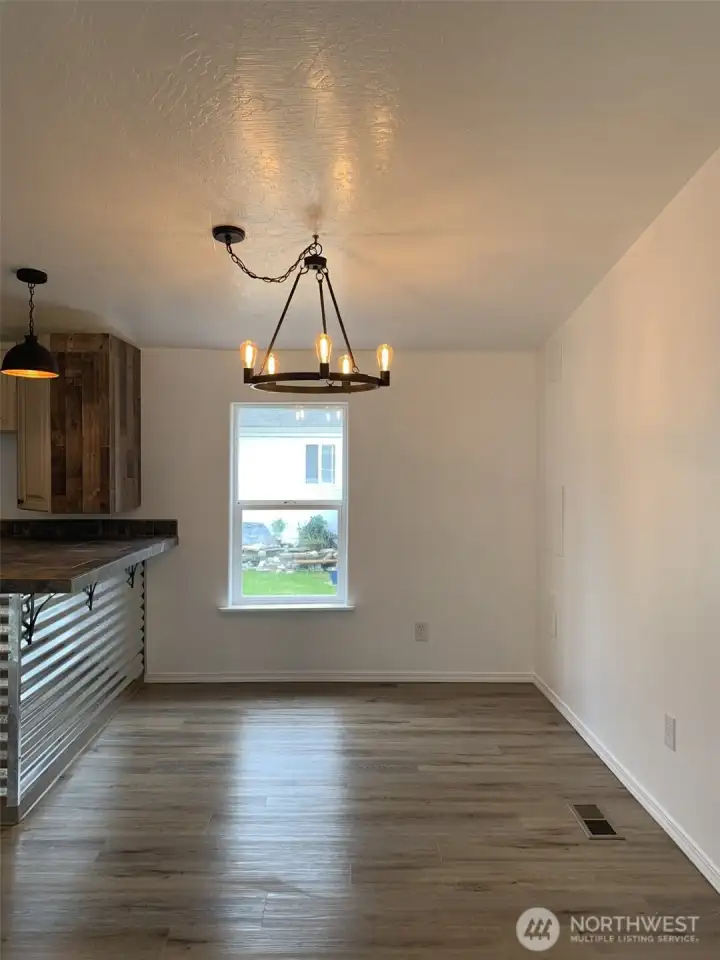Good size dining area with new light fixture, large window that lets in plenty of natural light and more!