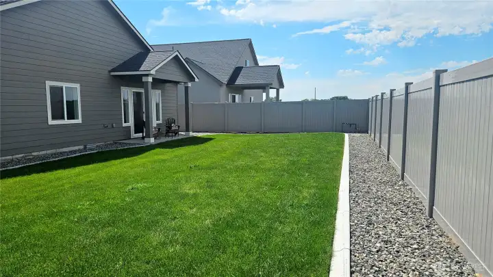 Fenced backyard, covered patio and landscaped.
