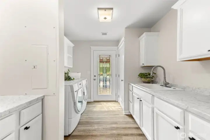 Laundry room with plenty of storage and access to back deck