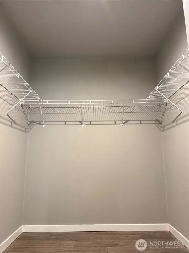 Walk in closet in primary bedroom.