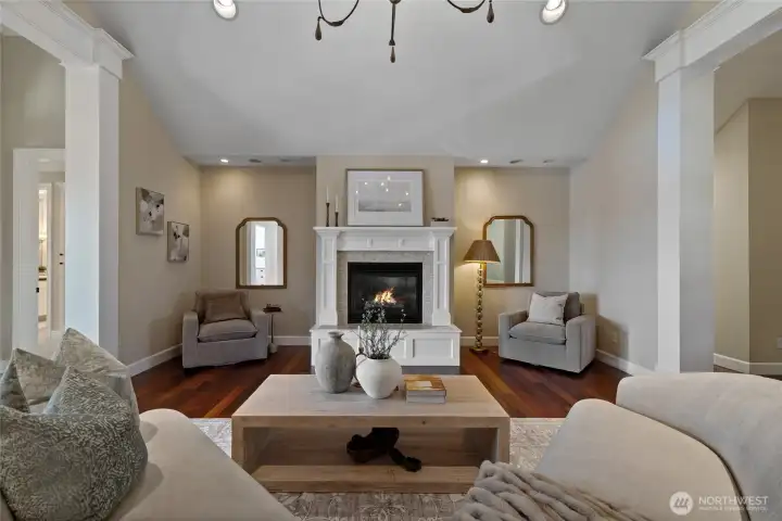 Formal living area features gas fireplace, perfect for relaxing evenings with guests.