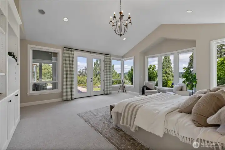 Primary bedroom features beautiful water views and french doors opening to the patio.