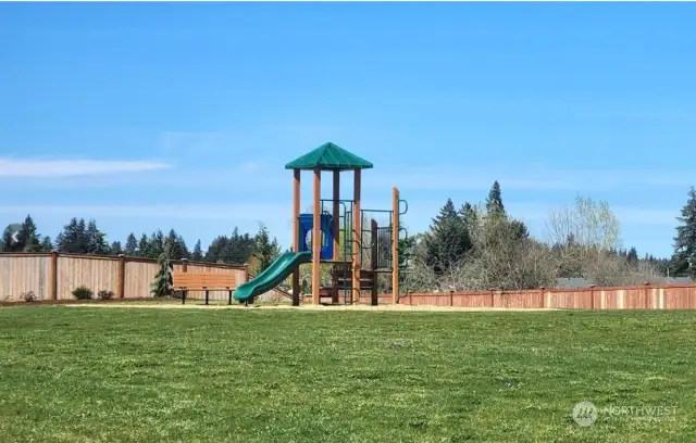 One of 2 community parks with play structure, benches, picnic tables and lots of green space!