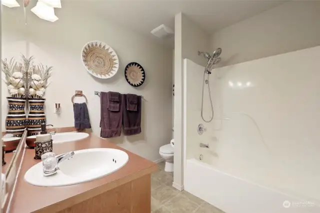 Additional full bathroom upstairs offers double sinks and a linen closet.