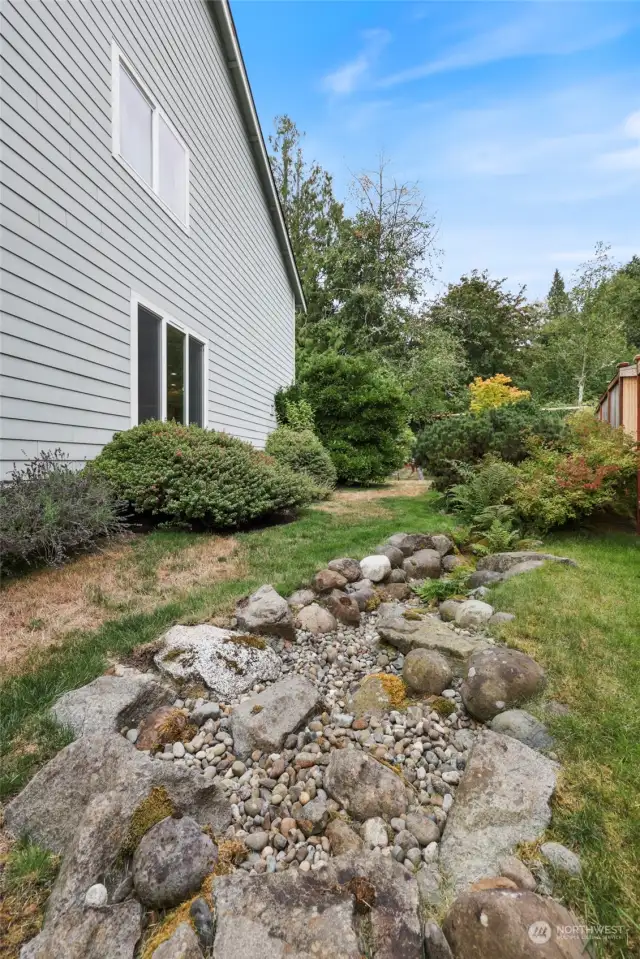 Great drainage package on this home to keep the crawlspace dry includes this lovely "brook" landscape feature.